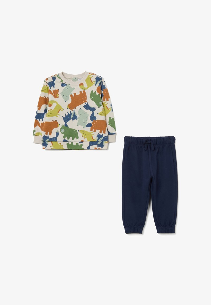 Twee-delige kinderoutfit met een crèmekleurige sweatshirt met kleurrijke dierenprints en marineblauwe broek met elastische taille. Katoenen stof, casual ontwerp.