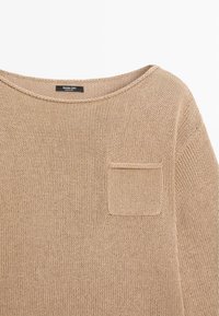 Beiger Strickpullover mit rundem Ausschnitt und kleinem Brusttasche, mit einem sichtbaren Massimo Dutti Markenetikett im Kragen.