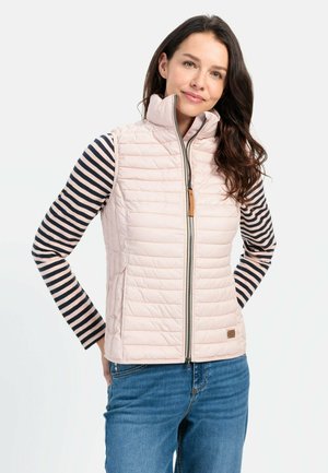 Light pink insulated vest with a high collar and quilted design. Worn over a navy and white striped long-sleeve shirt, featuring a zipper and leather accent.