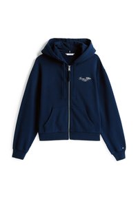 Sweat-shirt zippé bleu marine avec une poche avant, capuche à cordons, et logo brodé sur la poitrine. Fabriqué en tissu doux et texturé.