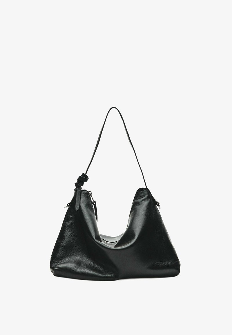 Black leather shoulder bag with a single thin strap and zipper closure, displayed against a white background.