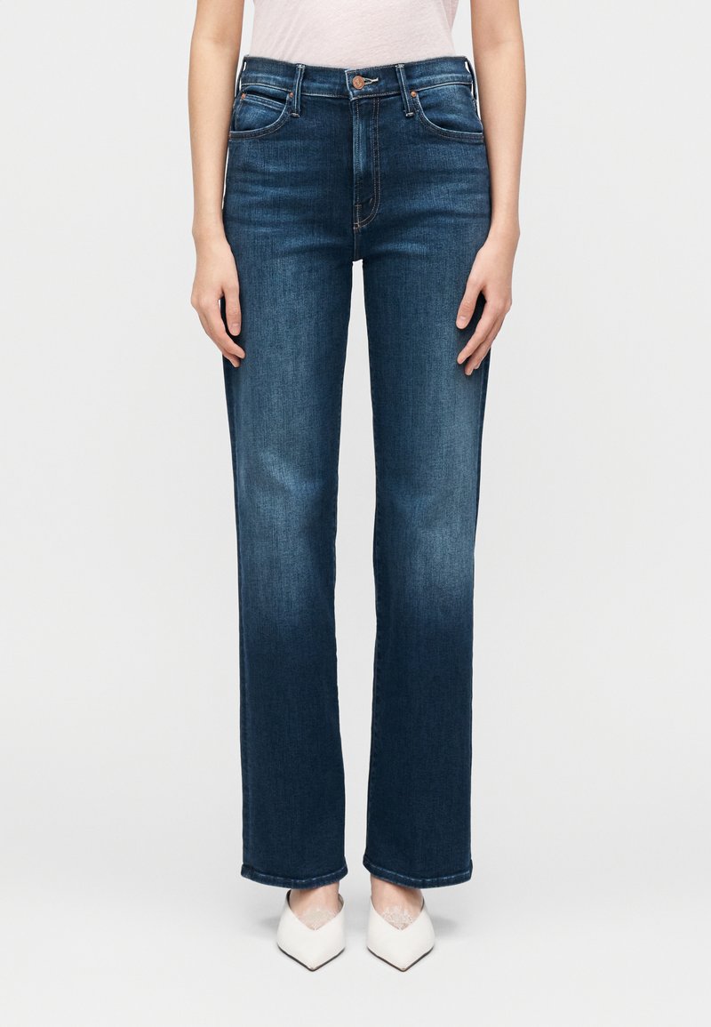 Tumesinised kõrge vöökohaga teksapüksid, sirgete säärte ja nähtava õmblusega. Püksidel on ees- ja tagataskud ning nööpkinnitus.