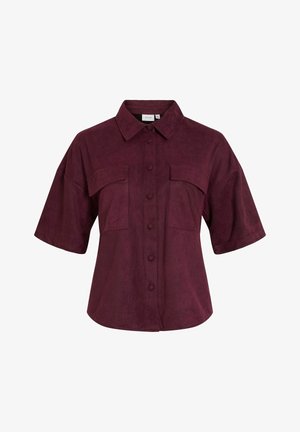 Camicia bordeaux a maniche corte in tessuto morbido e strutturato. Presenta una chiusura frontale con bottoni, due tasche sul petto e un colletto classico.
