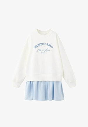 Bijela duga majica s natpisom "Monte Carlo Côte d'Azur Monaco" iznad svijetloplave i bijele vertikalno prugaste plisirane suknje pričvršćene na rubu.