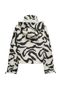 Giacca corta in beige chiaro con strisce zebra nere ondulate. Presenta un cappuccio, coulisse regolabili all'orlo e tasche frontali.