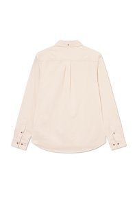 Long-sleeve beige shirt, soft fabric, classic collar, two buttoned cuffs, center pleat at back, curved hem, no patterns or accents.