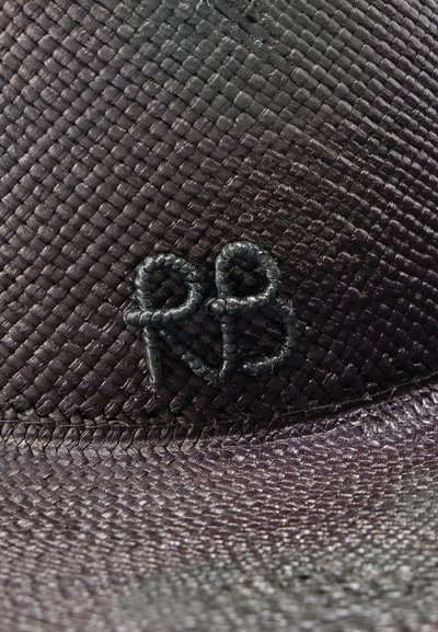 Μαύρο υφαντό υλικό με ανάγλυφη υφή και υφασμένα αρχικά "RB" σε μαύρο νήμα που ταιριάζει.