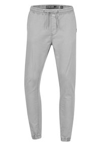 Pantalones de chándal grises con cintura elástica y cordón ajustable. Diseño de pierna ajustada y puños elásticos en los tobillos. Textura de tela suave.