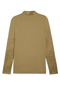 Langærmet skjorte i en tan farve, med et struktureret stof og mønstrede detaljer på ærmerne. Krave-design med en glat finish.