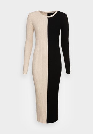 Knit dress with a ribbed texture, featuring a split design in beige and black. Long sleeves and a round neckline, midi length.