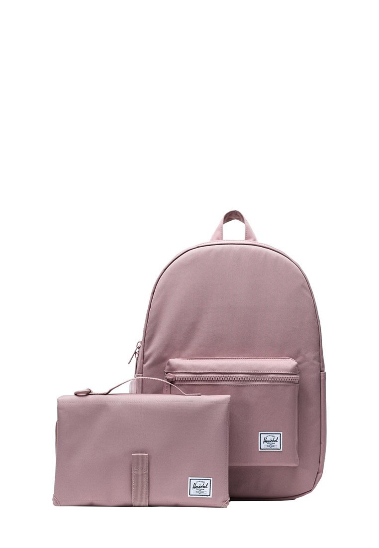 Rosa Herschel-Rucksack mit vorderem Reißverschlussfach und passendem rechteckigen Etui, beide mit weißen Markenetiketten auf weißem Hintergrund.