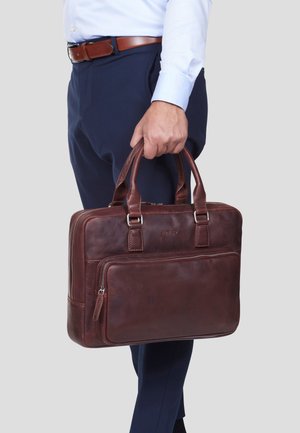Brown leather briefcase with dual top handles, a front zipper pocket, and polished silver hardware, exhibiting a smooth, durable texture.