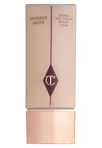Rechteckige beige Kosmetikflasche mit einem glänzenden bronzefarbenen Boden. Enthält dunkelbraunen Text und ein Diamant-Logo. Auf dem Etikett steht "Wonder Glow".