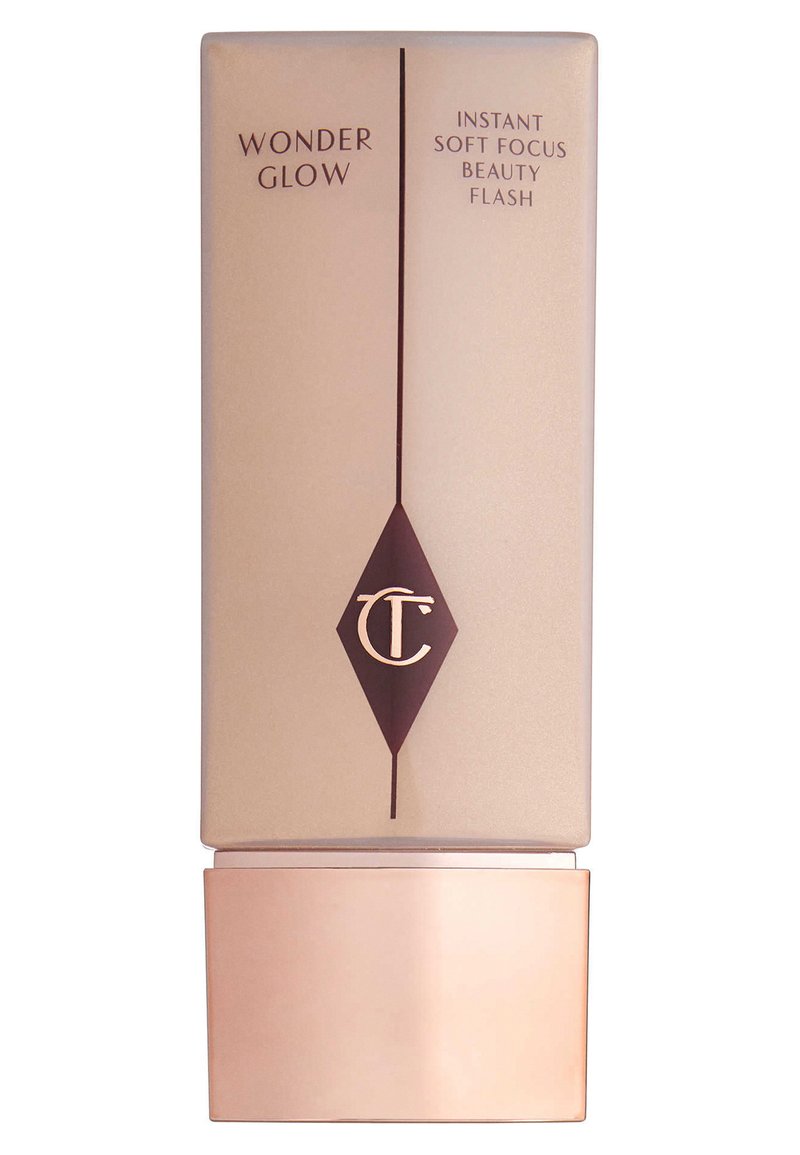 Rechteckige beige Kosmetikflasche mit einem glänzenden bronzefarbenen Boden. Enthält dunkelbraunen Text und ein Diamant-Logo. Auf dem Etikett steht "Wonder Glow".