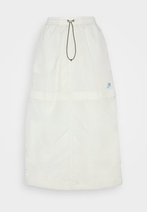 Long white skirt made of lightweight material. Features an elastic waistband, drawstring, and a small blue Nike logo on the bottom right.