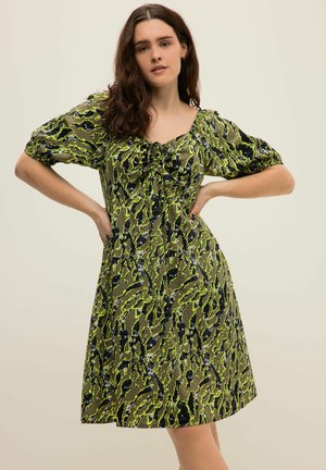 Grün und schwarz gemustertes Kleid mit Puffärmeln, einem quadratischen Ausschnitt und Raffung Detail vorne. Midikleid aus leichtem Stoff.