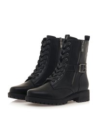 Bottes en cuir noir à lacets avec une fermeture éclair sur le côté, détail de boucle et semelle texturée. Présentent un bout rond et un bon maintien de la cheville.