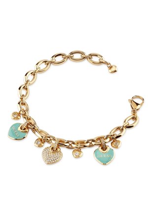 Gold chain bracelet featuring heart charms, two turquoise enamel hearts with "Guess," one heart with rhinestones, and small gold accents.