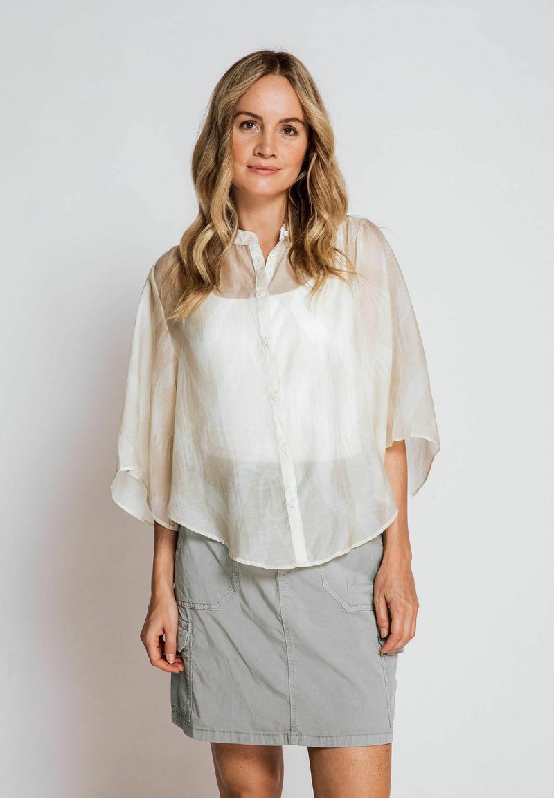 Translucent white button-up blouse with flutter sleeves and a relaxed fit, paired with a light gray knee-length skirt featuring pockets.
