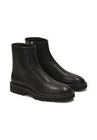 Black leather ankle boots with a smooth surface, rounded toe, and a chunky rubber sole featuring treaded detailing. Side zipper for closure.