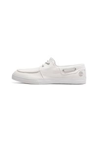 White canvas shoes with a low profile, featuring gray eyelets, a rubber sole, and a small logo on the heel. Smooth texture, casual design.