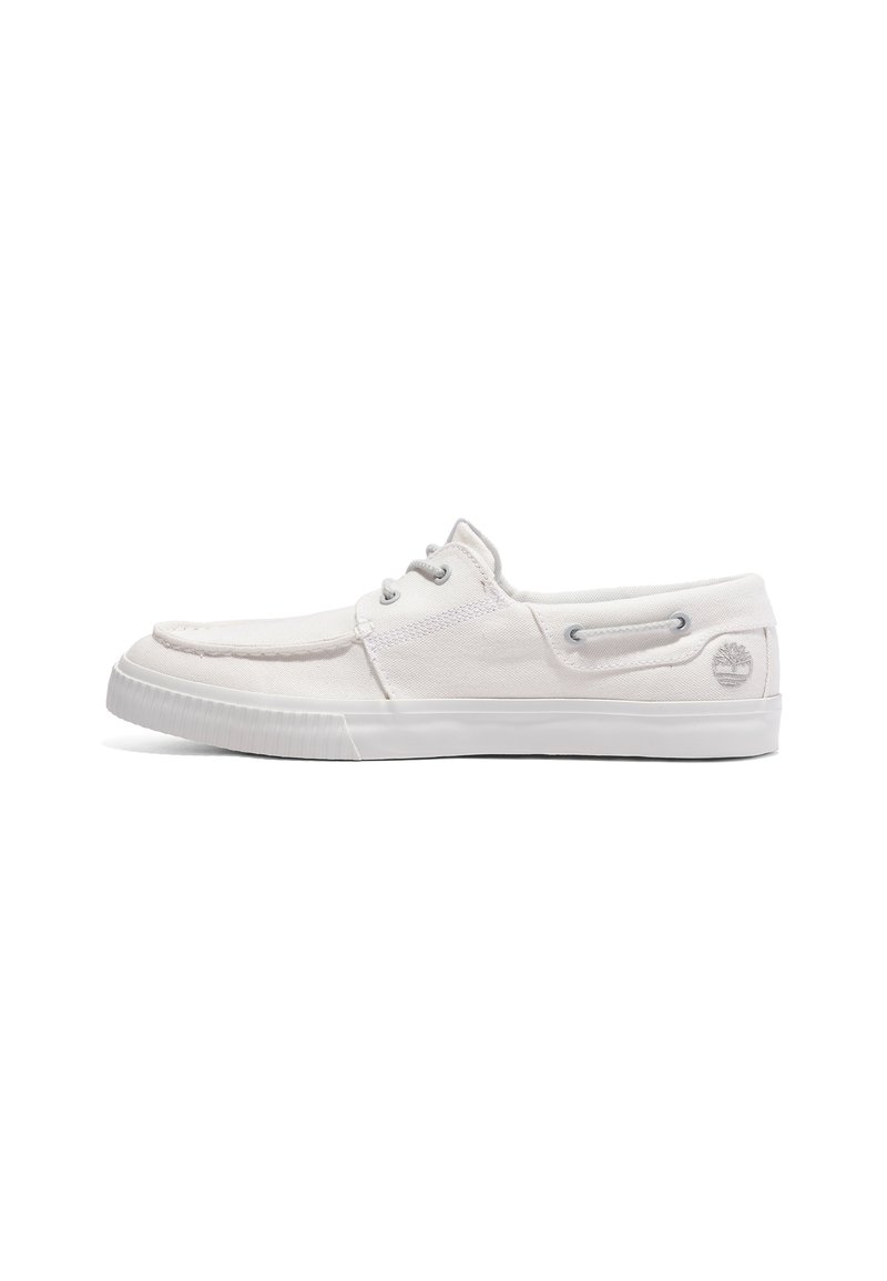 White canvas shoes with a low profile, featuring gray eyelets, a rubber sole, and a small logo on the heel. Smooth texture, casual design.