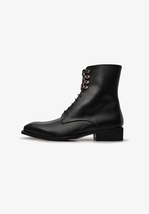 Black leather ankle boots with a pointed toe, six metal eyelets, and a stacked heel. Smooth texture with subtle stitching detail.