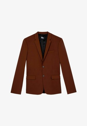 Bruine op maat gemaakte blazer met twee voorzakken, sluiting met één knop en gesneden revers. Textuurstof met een gladde zwarte binnenvoering.