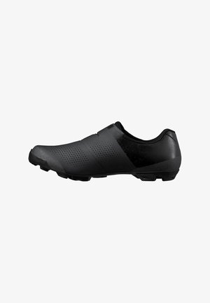 Zapato de ciclismo negro con parte superior perforada, cierre de velcro y suela con tacos diseñada para ciclismo de montaña.