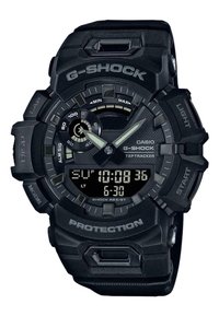 Montre Casio G-Shock avec un boîtier en résine noire robuste, un grand écran numérique, des aiguilles analogiques et un bracelet texturé. Résistante aux chocs.