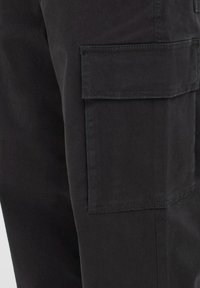 Black cargo pants with a smooth texture, featuring a large side pocket and reinforced stitching for durability.