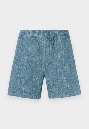 Traper kratke hlače s elastičnim pojasom, bljeđe plave boje i teksturiranog izgleda. Ravnog kroja bez džepova i ukrasa.