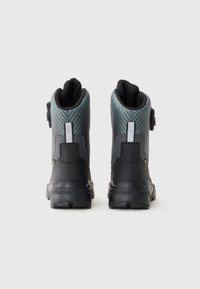 Sorte og grå højhælede støvler har en tekstureret mesh-overdel med en glat hælkappe, skrå sømme og en velcro-lukning.