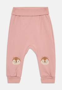 Pink cotton pants with a ribbed waistband and cuffs; features cartoon animal faces on knees. Soft texture, relaxed fit, and simple design.