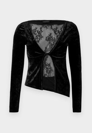 Black velvet long-sleeve top with a plunging neckline, featuring a lace insert and twisted front detail. Smooth texture, fitted design.