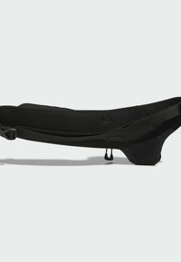 Black, mesh sling bag featuring a sleek design, adjustable straps, textured fabric, and streamlined shape suitable for carrying essentials.