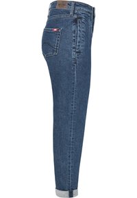 Dark blue denim jeans with a slim fit, featuring a rolled cuff at the ankle, back pocket with a white logo, and subtle stitching details.