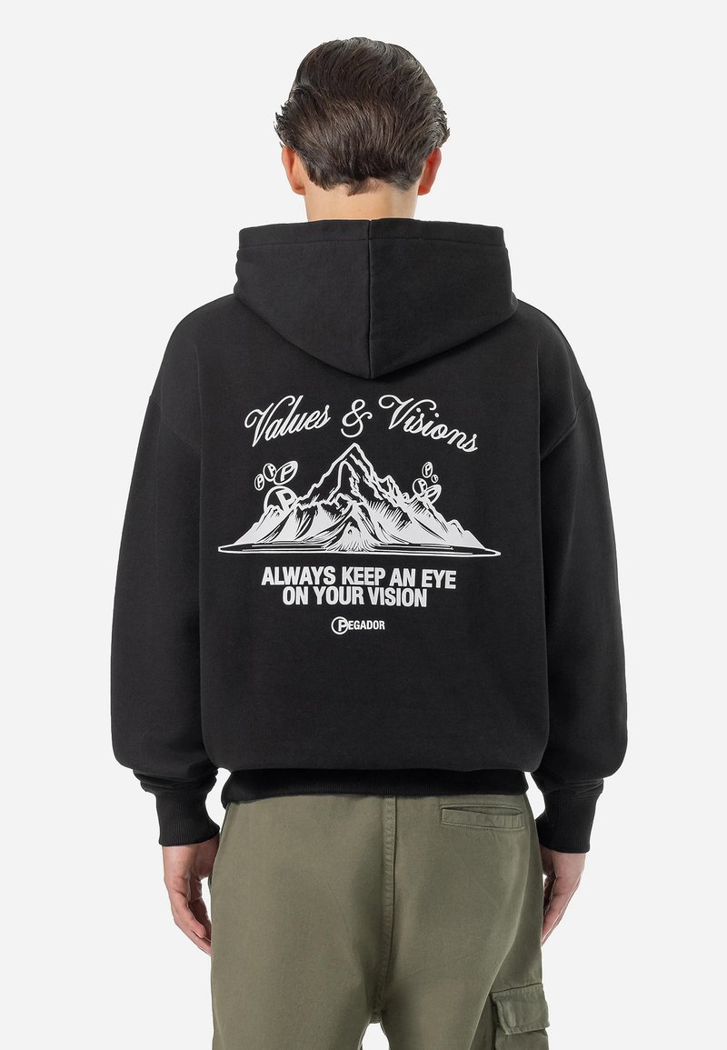 Black hooded sweatshirt featuring white graphic text and mountain design on the back. Ribbed cuffs and waistband, soft fabric texture.