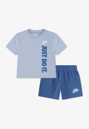 Light blue Nike kids' T-shirt with "JUST DO IT." text and matching blue Nike shorts with elastic waistband and logo.