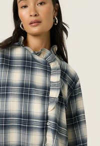 Soaked in Luxury Blouse - navy checks