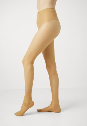 Collants chair jusqu'aux genoux avec une texture lisse et transparente, taille haute et partie renforcée au niveau des orteils, conçus pour le confort et un aspect naturel.