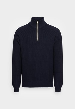 Navy blue knitted pullover with a high collar and half-zip closure. Features ribbed texture and relaxed fit at the hem and cuffs.