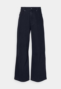 Tmavě modré široké džíny vyrobené z denimové bavlny, s knoflíkovým zapínáním, poutky na opasek a předními kapsami. Hladká textura bez vzorů.