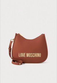 Brown leather shoulder bag with curved shape, gold "LOVE MOSCHINO" lettering, and a detachable strap. Zip closure on top.