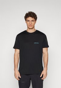 Black crew neck t-shirt made of soft fabric, featuring a small blue "icebreaker" logo on the left side, short sleeves, and a relaxed fit.