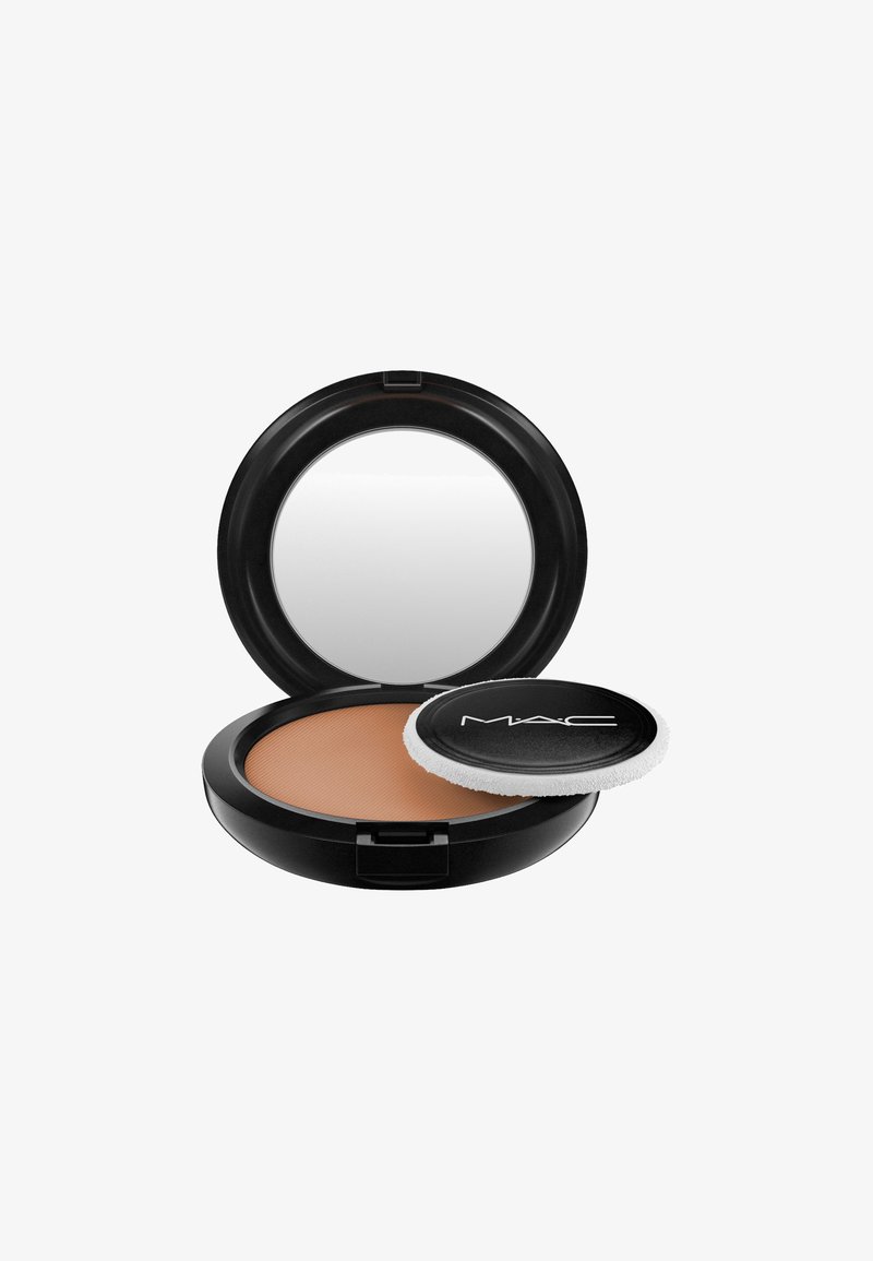 Compact rond noir avec un miroir ; comprend un bronzer texturé et un applicateur en mousse. Le bronzer a une teinte bronzée chaude et une surface lisse.