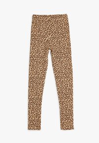Leggings en imprimé léopard dans une palette de couleurs beige et brun, présentant un tissu extensible et un design ajusté sans coutures visibles.