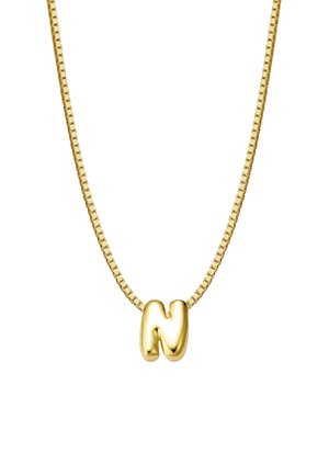Zelta ķēdīte ar gludu, noapaļotu burta "N" piekariņu. Ķēdīte ir ar kvadrātveida saitēm, kas uzlabo kopējo dizainu un tekstūru.