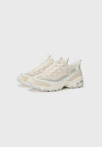 Beige sports shoes with a mesh upper and smooth leather accents, featuring a chunky white sole, textured toe cap, and lace-up design.
