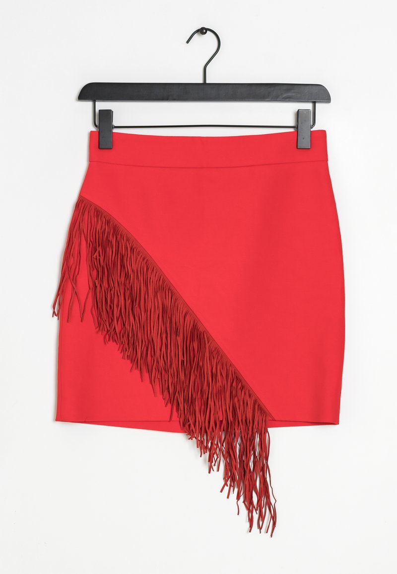 Red mini skirt with a side fringe detail; smooth texture and fitted design, hanging on a black hook against a white background.